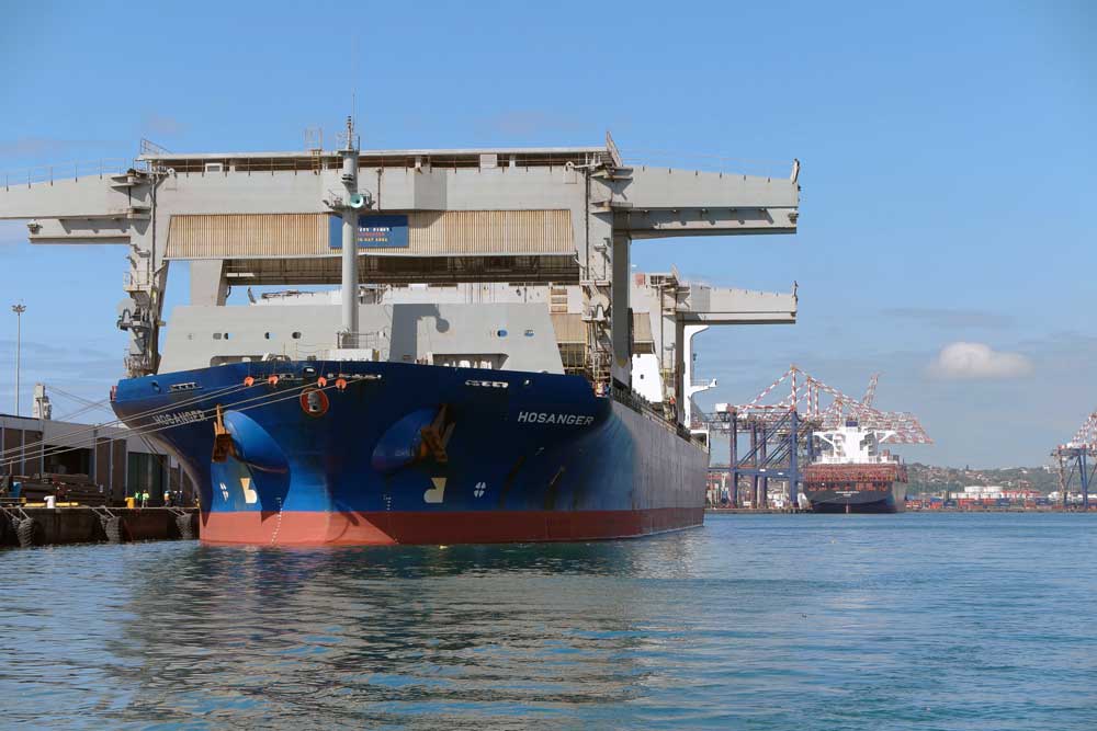 Large cargo vessel Hosanger docked at Durban harbour showing industrial port cranes
