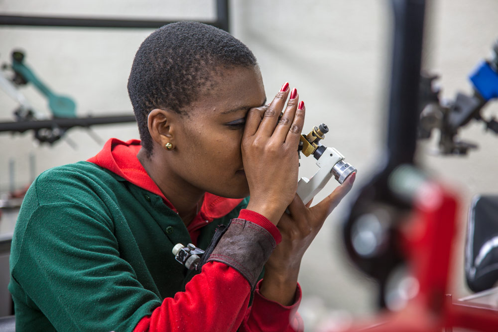 Diamond grading specialist examining gemstone with precision loupe, Botswana