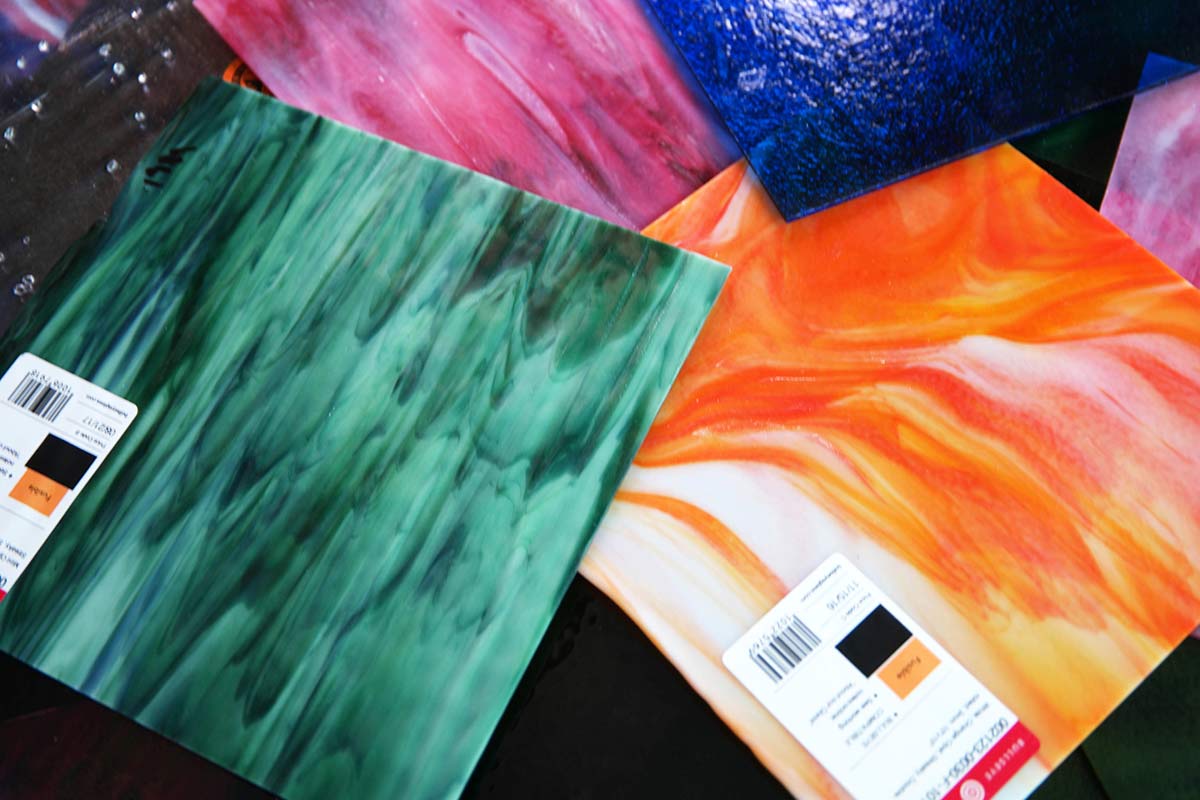 Colourful handmade glass art panels showing vibrant patterns created at disability empowerment workshop